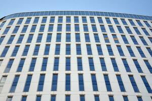 Modern office building in the city with windows and  steel and aluminum panels wall. Contemporary commercial architecture, vertical converging geometric lines. photo