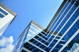 Modern office building in the city with windows and  steel and aluminum panels wall. Contemporary commercial architecture, vertical converging geometric lines. photo