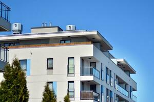 Residential Building on sky background. Facade of a modern housing construction with of balconies. photo