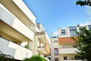 Residential Building on sky background. Facade of a modern housing construction with of balconies. photo