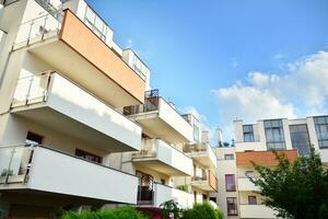 Residential Building on sky background. Facade of a modern housing construction with of balconies. photo