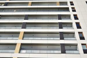 Residential Building on sky background. Facade of a modern housing construction with of balconies. photo