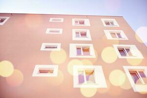 Residential Building on sky background. Facade of a modern housing construction with of balconies. photo