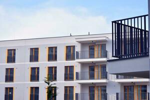Residential Building on sky background. Facade of a modern housing construction with of balconies. photo
