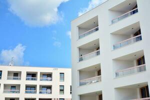 Residential Building on sky background. Facade of a modern housing construction with of balconies. photo
