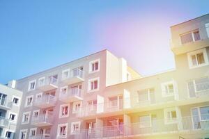 Residential Building on sky background. Facade of a modern housing construction with of balconies. photo