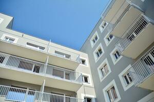 Residential Building on sky background. Facade of a modern housing construction with of balconies. photo