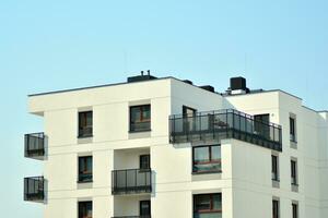 Residential Building on sky background. Facade of a modern housing construction with of balconies. photo