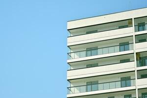 Residential Building on sky background. Facade of a modern housing construction with of balconies. photo