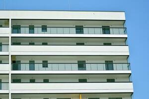 Residential Building on sky background. Facade of a modern housing construction with of balconies. photo