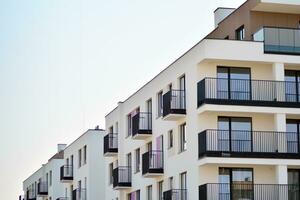 Residential Building on sky background. Facade of a modern housing construction with of balconies. photo