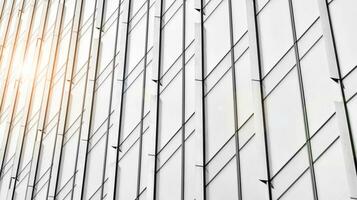 Glass modern building with blue sky background. View and architecture details. Urban abstract - windows of glass office building in  sunlight day. Black and white. photo