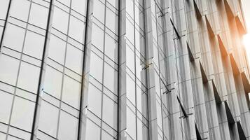 Glass modern building with blue sky background. View and architecture details. Urban abstract - windows of glass office building in  sunlight day. Black and white. photo