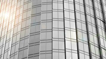 Glass modern building with blue sky background. View and architecture details. Urban abstract - windows of glass office building in  sunlight day. Black and white. photo