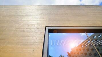 Minimalist photo of an exterior of a modern tin building with big glass showcases.