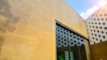 Minimalist photo of an exterior of a modern tin building with big glass showcases.