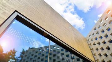 Minimalist photo of an exterior of a modern tin building with big glass showcases.