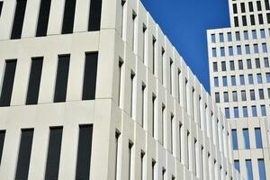 Modern office building detail. Perspective view of geometric angular concrete windows on the facade of a modernist brutalist style building. photo