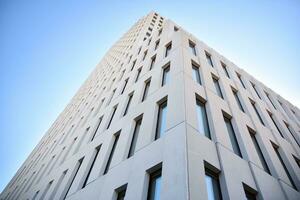 Modern office building detail. Perspective view of geometric angular concrete windows on the facade of a modernist brutalist style building. photo