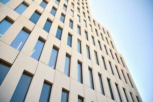 Modern office building detail. Perspective view of geometric angular concrete windows on the facade of a modernist brutalist style building. photo