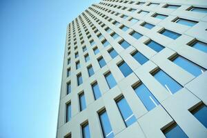 Modern office building detail. Perspective view of geometric angular concrete windows on the facade of a modernist brutalist style building. photo