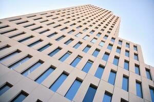 Modern office building detail. Perspective view of geometric angular concrete windows on the facade of a modernist brutalist style building. photo