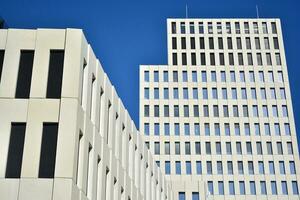 Modern office building detail. Perspective view of geometric angular concrete windows on the facade of a modernist brutalist style building. photo