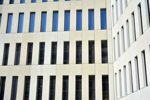 Modern office building detail. Perspective view of geometric angular concrete windows on the facade of a modernist brutalist style building. photo