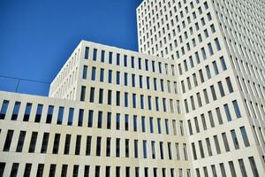 Modern office building detail. Perspective view of geometric angular concrete windows on the facade of a modernist brutalist style building. photo