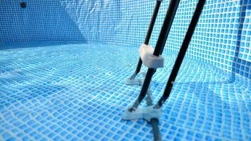 Water flowing from the hose into the pool filling. The inside of the swimming pool. photo