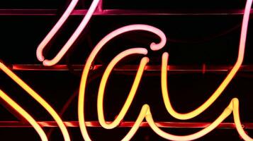 Glowing fragment of a neon sign, close-up, abstract background photo