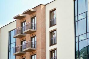 Fragment of modern luxury residential apartment,  home house building concept. Modern apartment building on a sunny day with a blue sky. photo