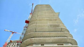 Residential building under construction. Building under construction against blue sky photo