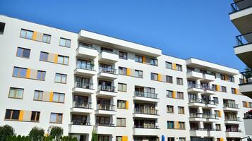 Modern apartment buildings on a sunny day with a blue sky. Facade of a modern apartment building photo