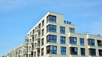 Modern apartment buildings on a sunny day with a blue sky. Facade of a modern apartment building photo