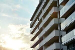 Modern apartment buildings on a sunny day with a blue sky. Facade of a modern apartment building photo