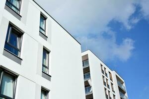 Modern apartment buildings on a sunny day with a blue sky. Facade of a modern apartment building photo