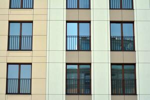 Cityscape with facade of a modern residential building. Modern European residential apartment building. photo