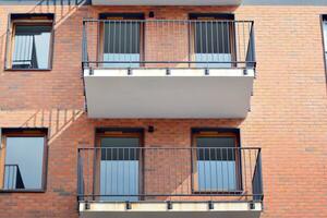 Cityscape with facade of a modern residential building. Modern European residential apartment building. photo