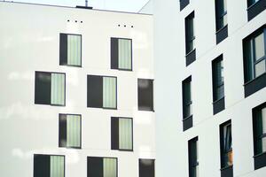 Cityscape with facade of a modern residential building. Modern European residential apartment building. photo