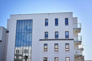 Cityscape with facade of a modern residential building. Modern European residential apartment building. photo