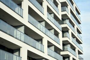 Exterior of a modern multi-story apartment building - facade, windows and balconies. photo