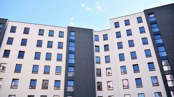 Exterior of a modern multi-story apartment building - facade, windows and balconies. photo