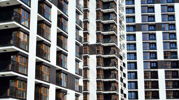 Exterior of a modern multi-story apartment building - facade, windows and balconies. photo