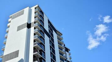 Exterior of a modern multi-story apartment building - facade, windows and balconies. photo