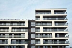 Exterior of a modern multi-story apartment building - facade, windows and balconies. photo