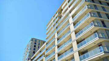 Exterior of a modern multi-story apartment building - facade, windows and balconies. photo