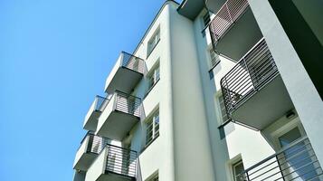 Exterior of a modern multi-story apartment building - facade, windows and balconies. photo