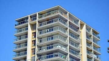 Exterior of a modern multi-story apartment building - facade, windows and balconies. photo