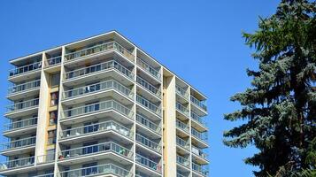 Exterior of a modern multi-story apartment building - facade, windows and balconies. photo